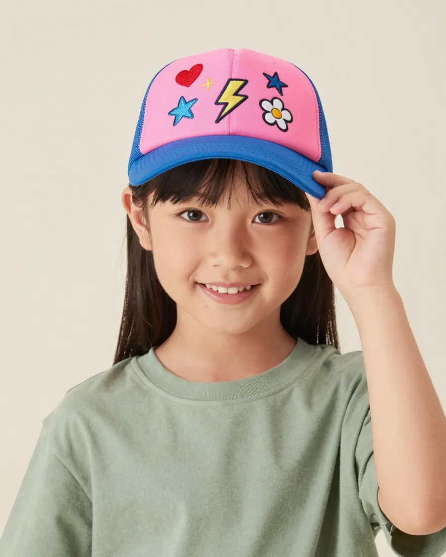 A child wearing a trucker cap covered in patches